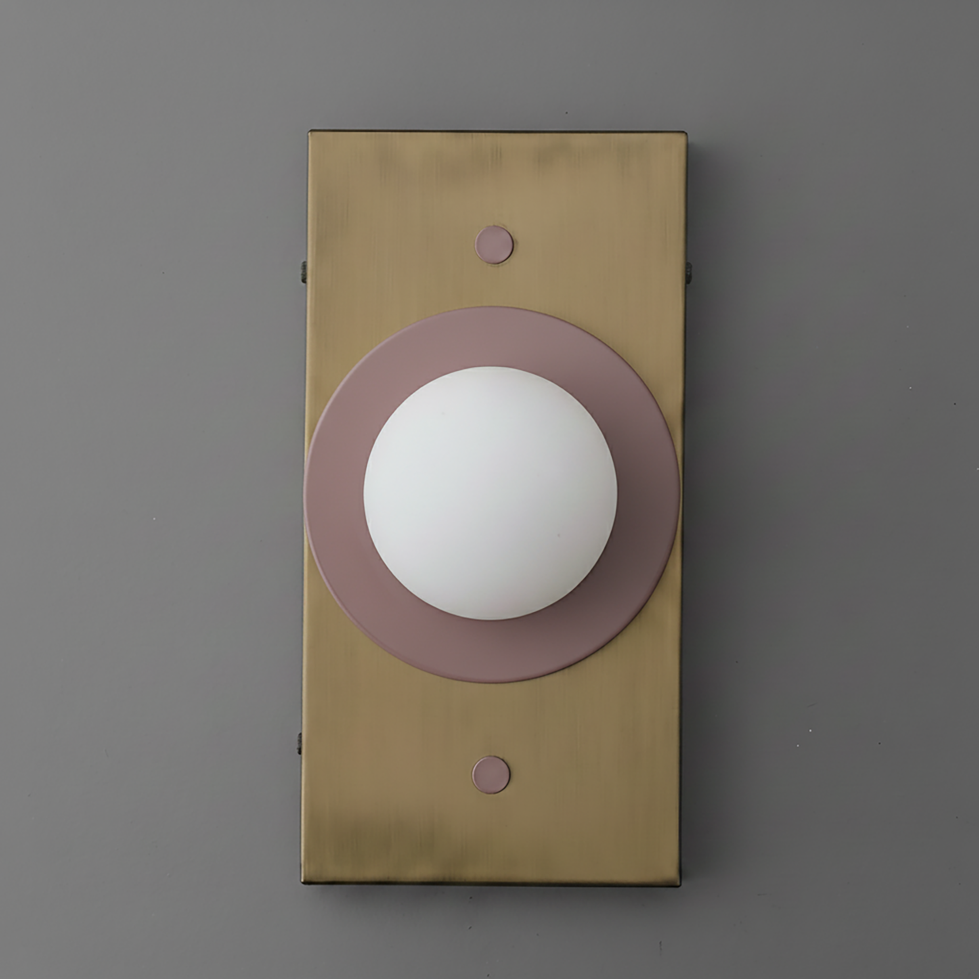 Minimalist wall sconce with antique brass rectangular backplate and mauve circular accent around white globe light. - SCONCE MODEL NO. 4474