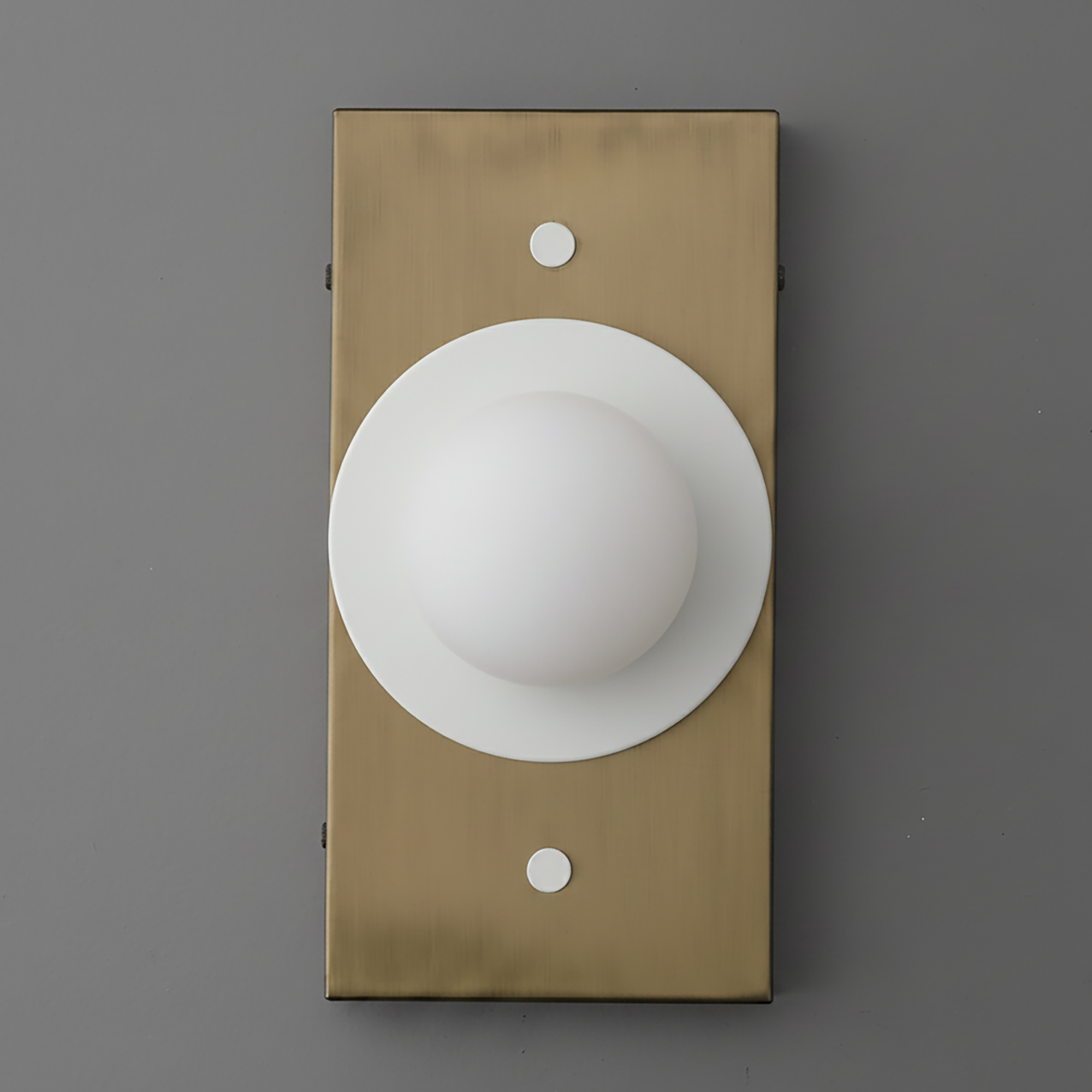 Antique brass rectangular sconce with white globe shade and circular backplate on gray background. - SCONCE MODEL NO. 4474