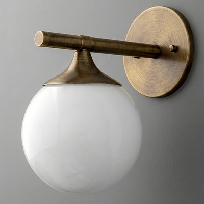 Antique brass wall sconce with a round backplate and white glass globe shade. - SCONCE MODEL NO. 1098