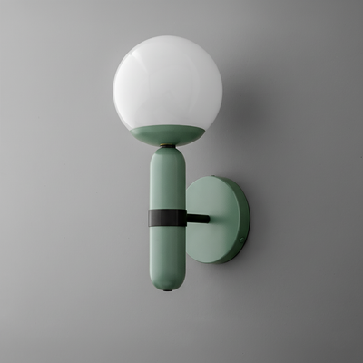 Wall sconce with matte green cylindrical base, black metal accent, and round white glass globe shade. - SCONCE MODEL NO. 4786