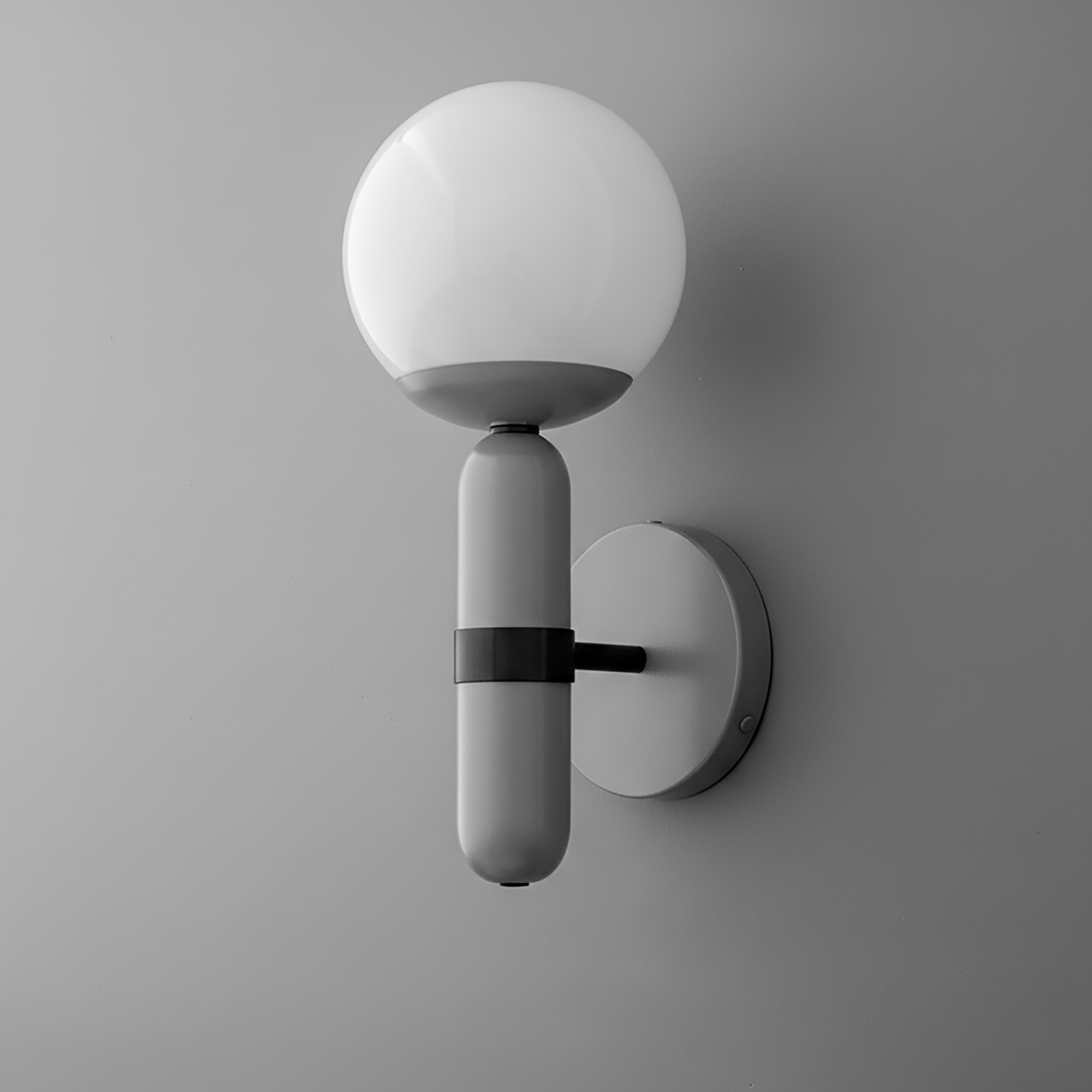 Wall sconce with matte gray cylindrical base and frosted white glass globe shade mounted on gray round backplate. - SCONCE MODEL NO. 4786