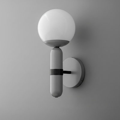 Wall sconce with matte gray cylindrical base and frosted white glass globe shade mounted on gray round backplate. - SCONCE MODEL NO. 4786