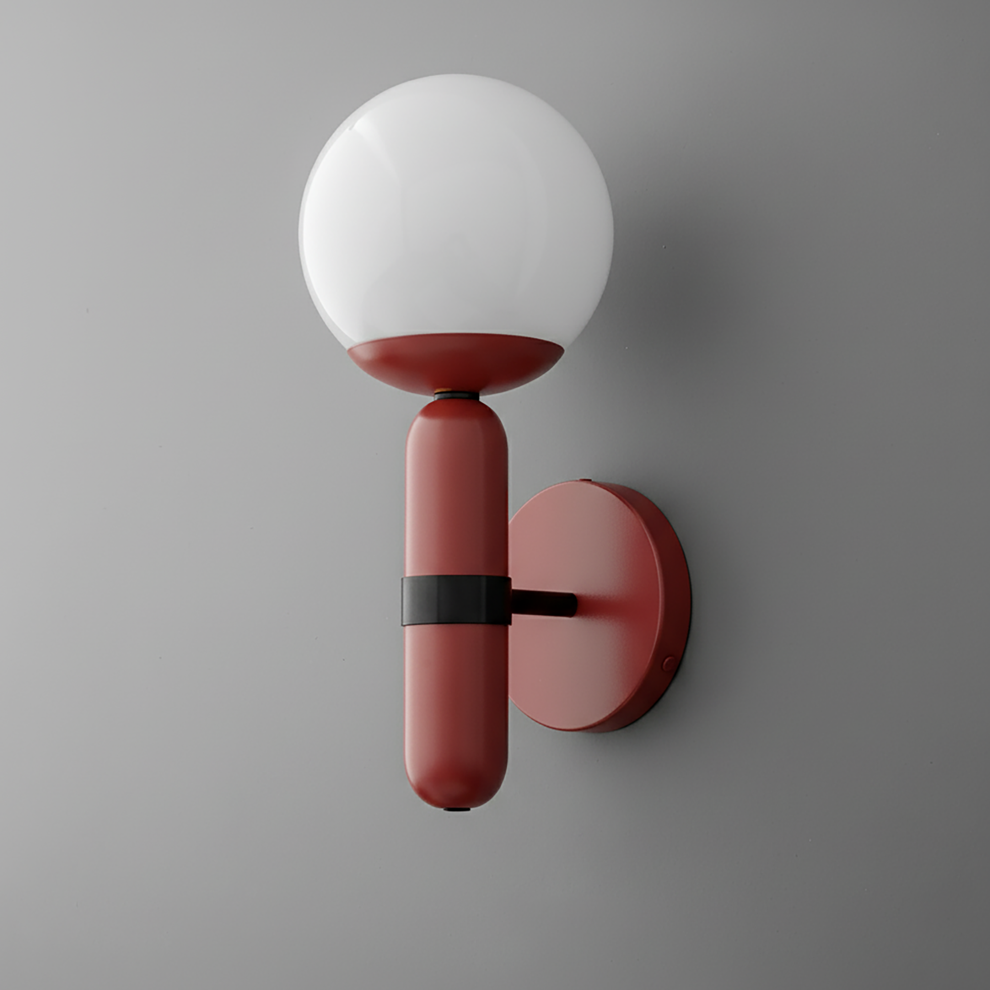 Wall sconce with matte brick red cylindrical base and white round glass globe shade mounted on gray wall. - SCONCE MODEL NO. 4786