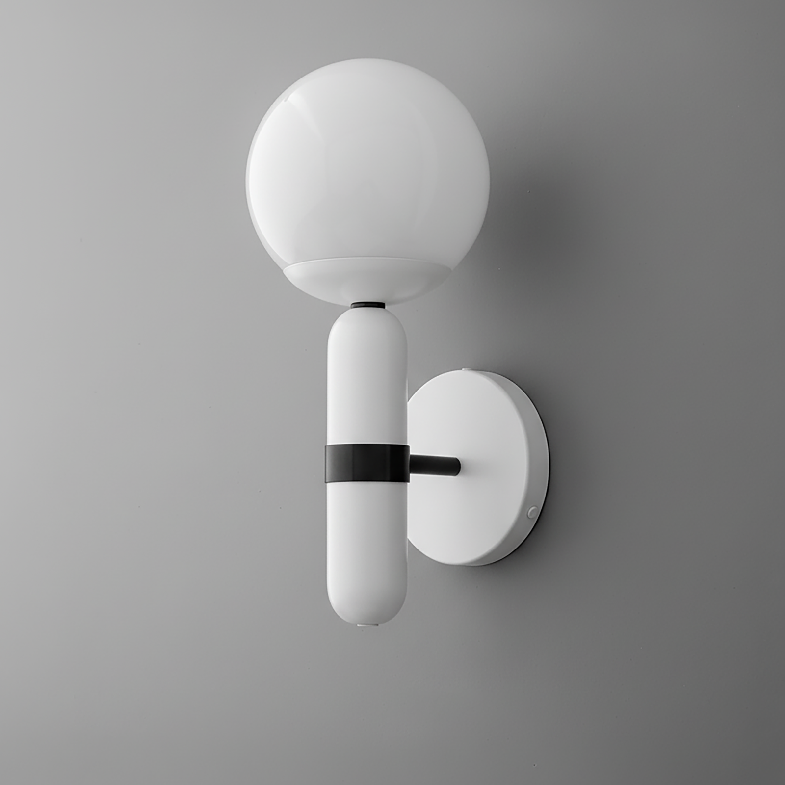 Modern white sconce with a round frosted glass globe and black metal accent on a white circular wall mount. - SCONCE MODEL NO. 4786