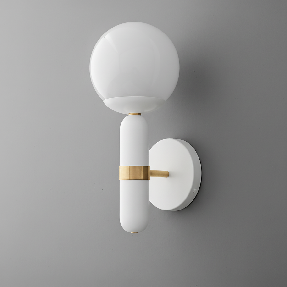 Wall sconce with white globe shade and white cylindrical base accented by raw brass band and mounting bracket. - SCONCE MODEL NO. 4786