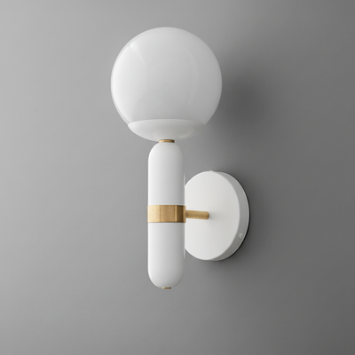 Wall sconce with white globe shade and white cylindrical base accented by raw brass band and mounting bracket. - SCONCE MODEL NO. 4786