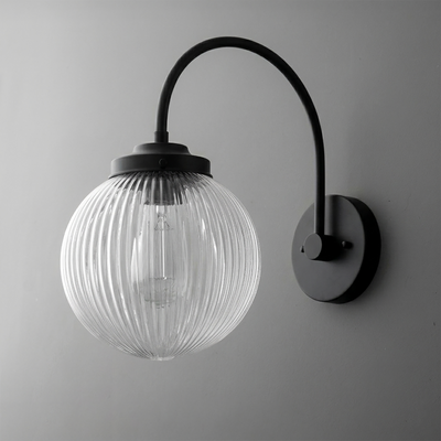 Black metal wall sconce with curved arm and ribbed clear glass globe shade. - SCONCE MODEL NO. 8763