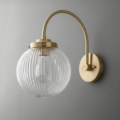 Wall sconce with ribbed clear glass globe shade and curved antique brass arm and base. - SCONCE MODEL NO. 8763