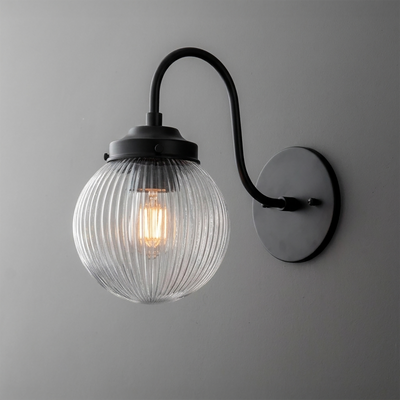 Black metal wall sconce with curved arm and ribbed clear glass globe shade, single bulb design. - SCONCE MODEL NO. 0691