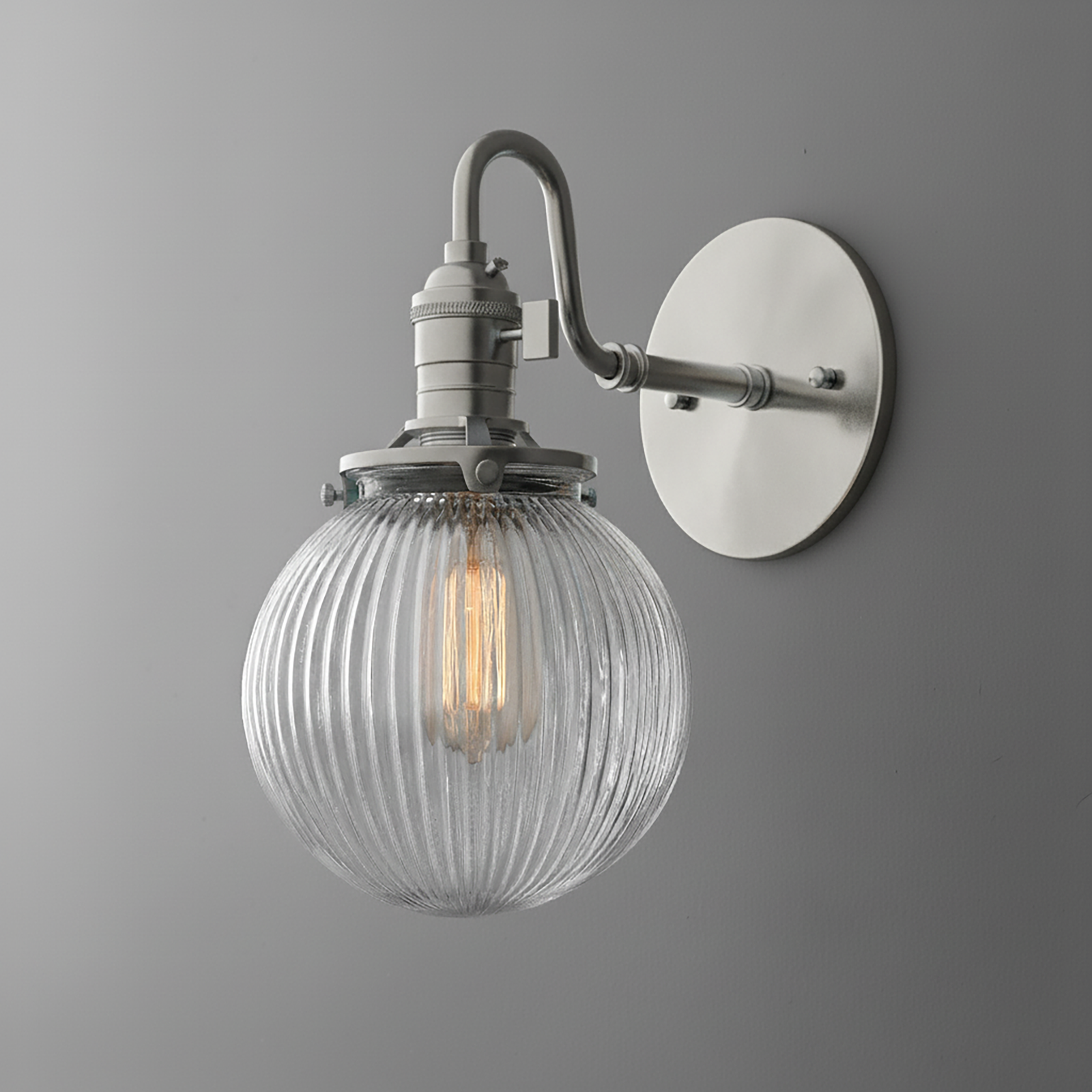 Wall-mounted sconce with ribbed clear glass globe and brushed nickel finish. - SCONCE MODEL NO. 3331