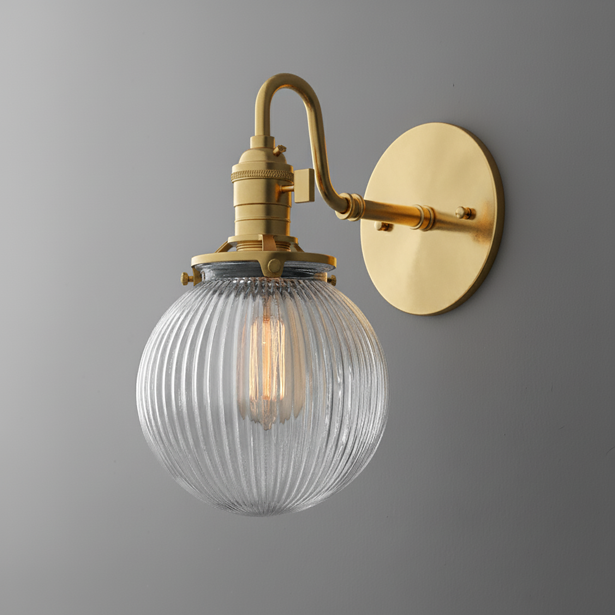 Antique brass wall sconce with ribbed clear glass globe shade and exposed filament bulb. - SCONCE MODEL NO. 3331