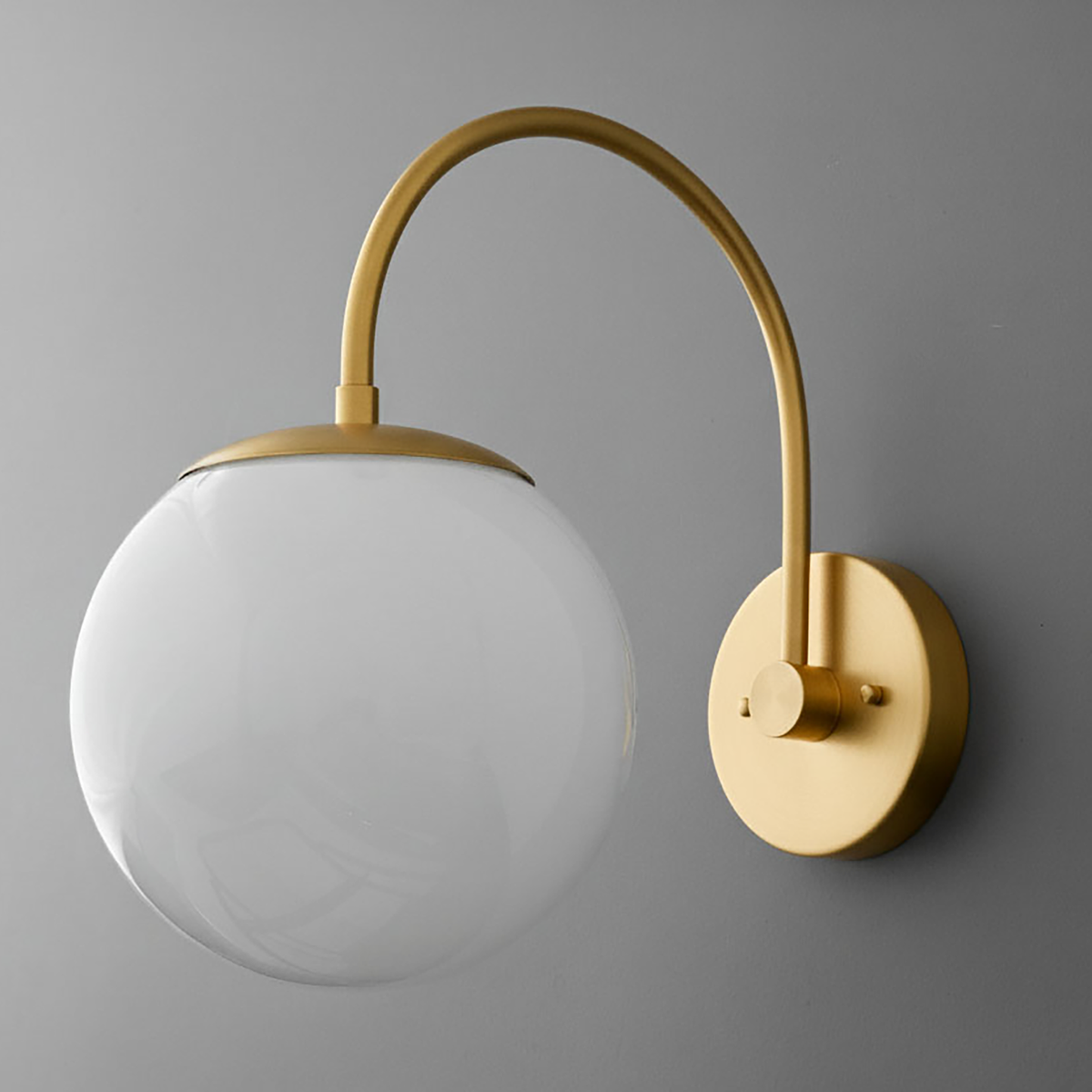 Modern wall sconce with a matte brass finish and a large frosted glass globe shade. - SCONCE MODEL NO. 2947