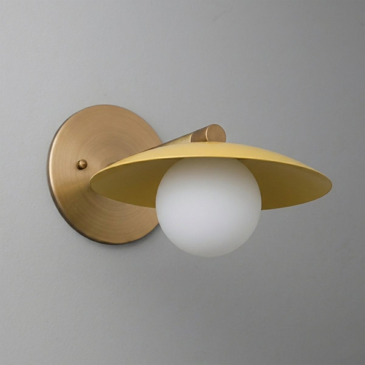 Brushed brass wall sconce with matte yellow conical shade and frosted white globe bulb. - SCONCE MODEL NO. 9872
