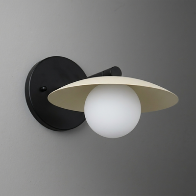 Matte black metal wall sconce with a wide cream-colored conical shade and a frosted white globe bulb beneath. - SCONCE MODEL NO. 9872