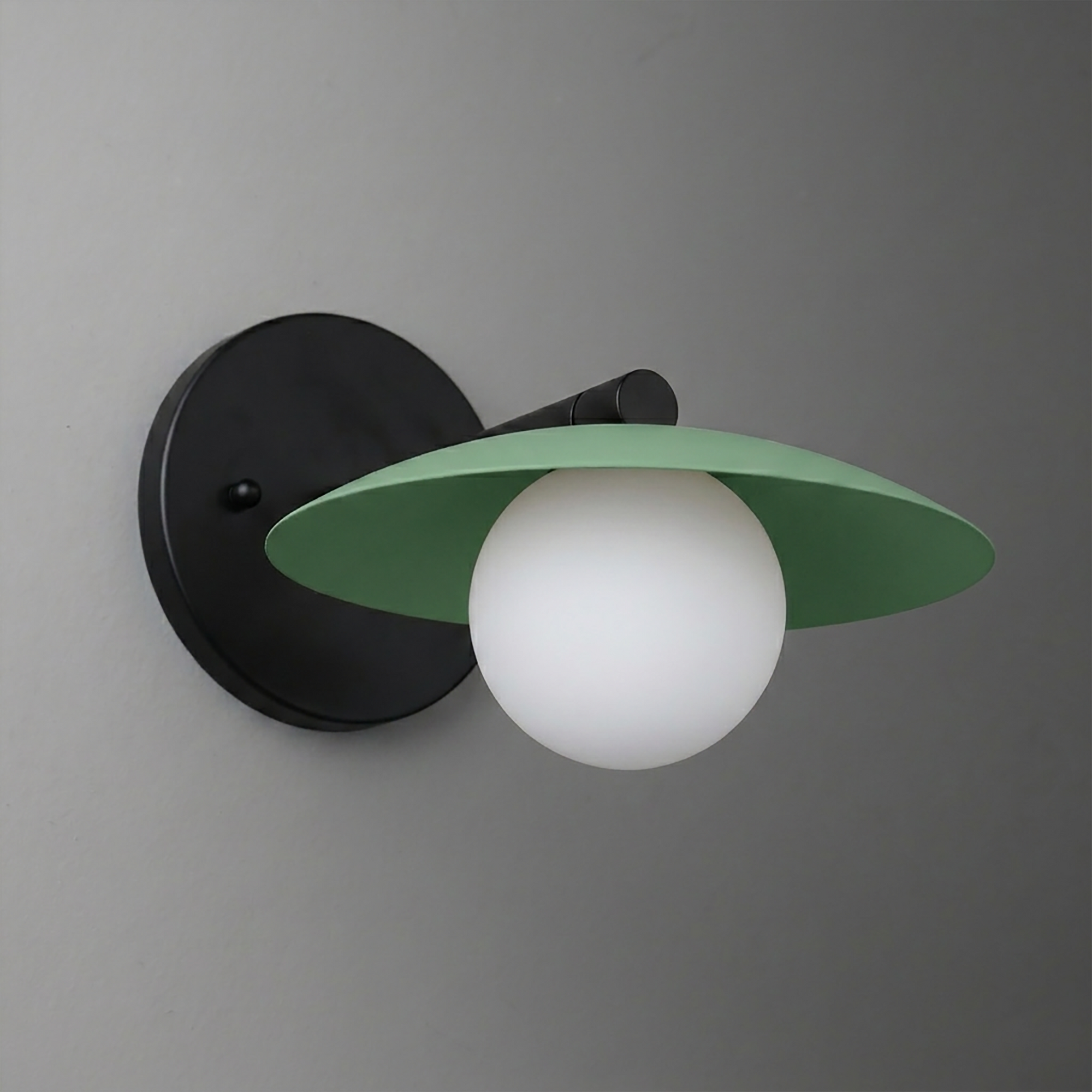 Black metal wall sconce with green wide flat shade and white glass globe bulb. - SCONCE MODEL NO. 9872