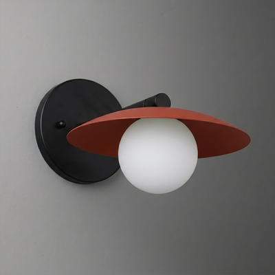 Black metal wall sconce with a matte terracotta flat dome shade and a white frosted glass globe bulb. - SCONCE MODEL NO. 9872