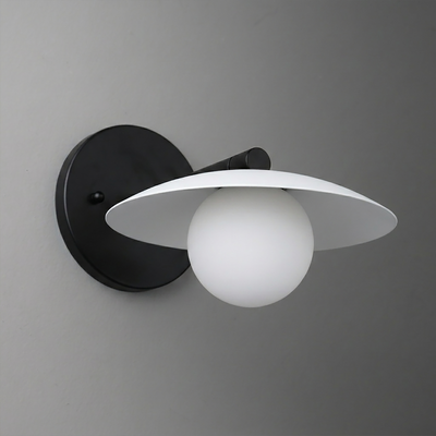 Black metal wall sconce with a white globe bulb and flat circular shade. - SCONCE MODEL NO. 9872