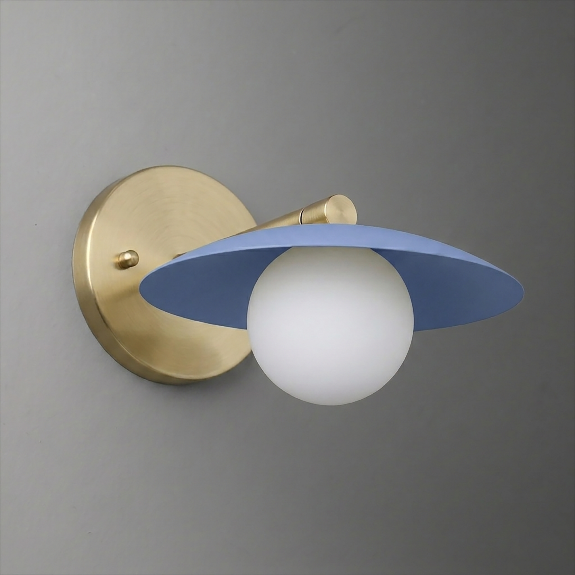 Wall sconce with matte blue flat metal shade and frosted white globe bulb on brushed brass mount. - SCONCE MODEL NO. 9872