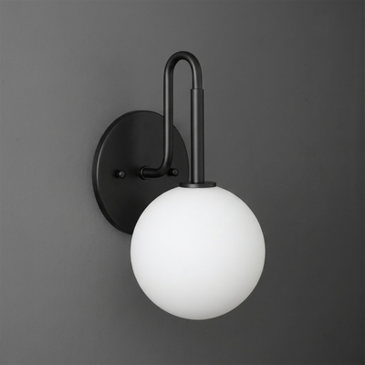 Matte black metal wall sconce with a curved arm and frosted white glass globe shade. - SCONCE MODEL NO. 9106
