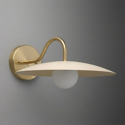 Brushed brass wall sconce with curved arm and flat cream-colored metal shade over white globe bulb. - SCONCE MODEL NO. 2162