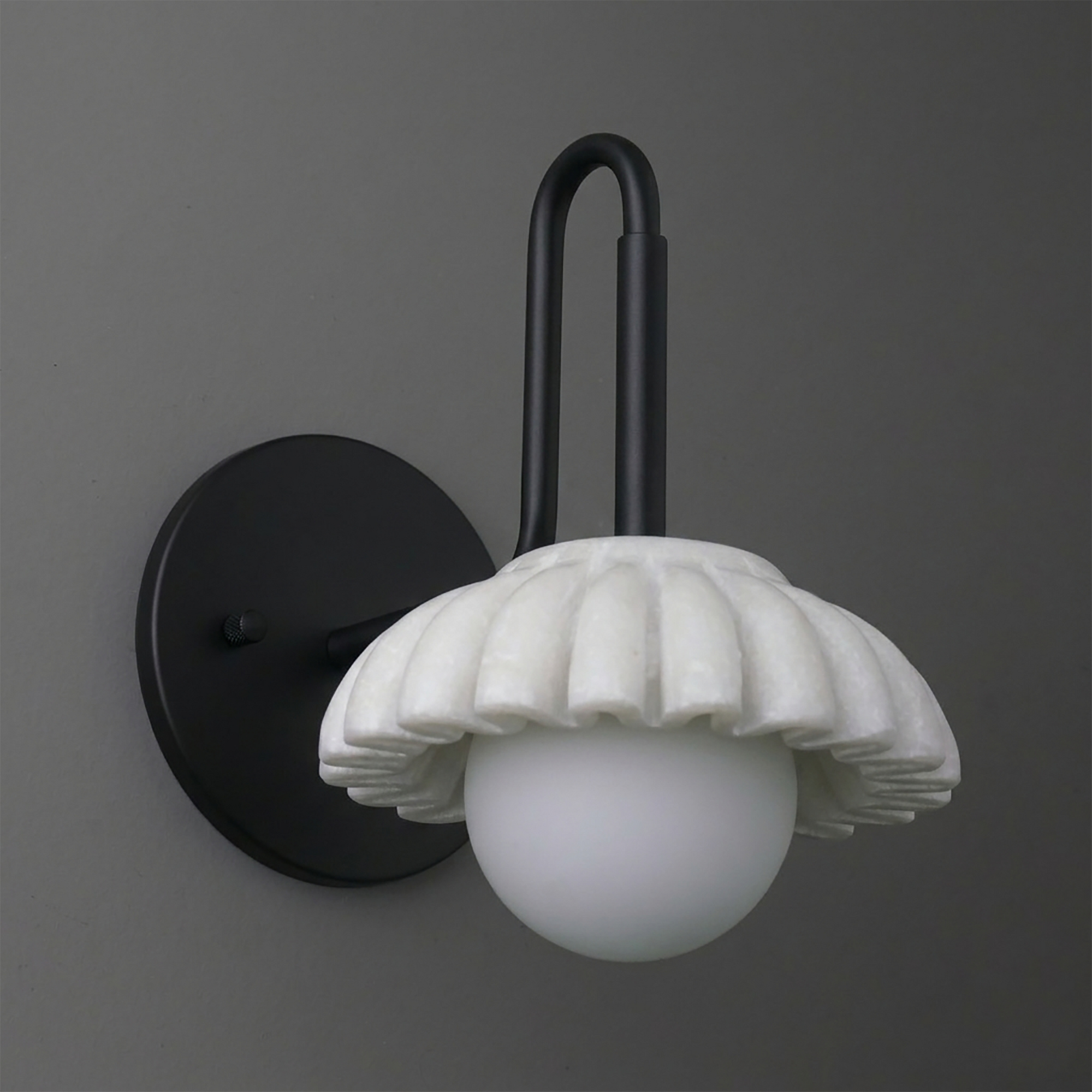 Modern black metal wall sconce with fluted white ceramic shade and round frosted glass globe bulb. - SCONCE MODEL NO. 8633