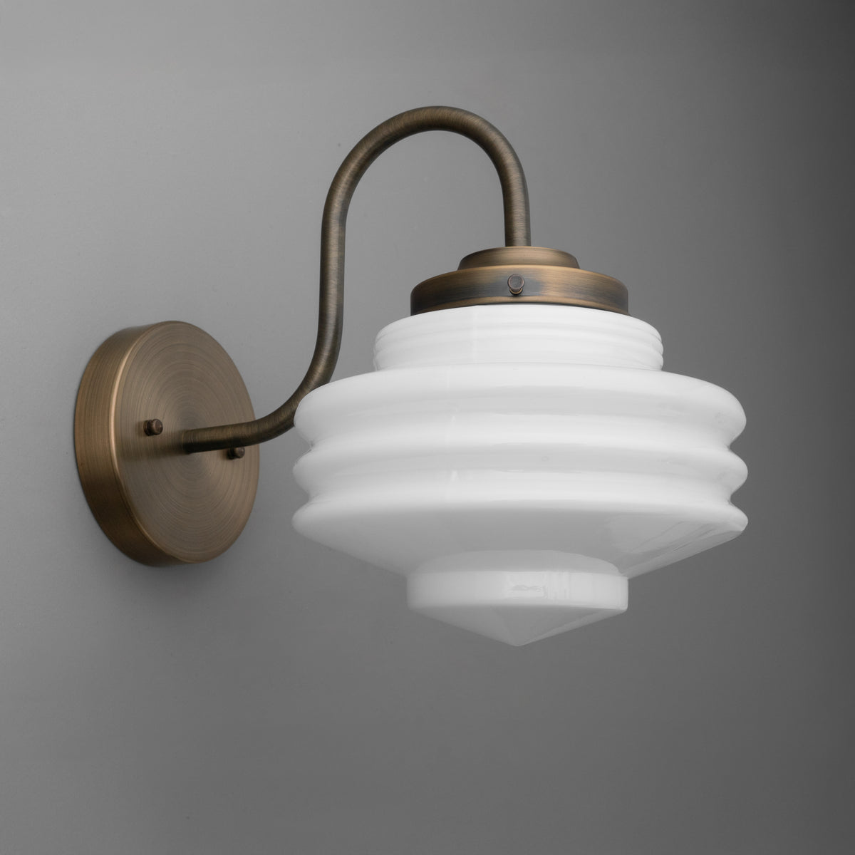 Antique bronze 1-bulb wall sconce with curved arm and layered white glass shade. - SCONCE MODEL NO. 1096