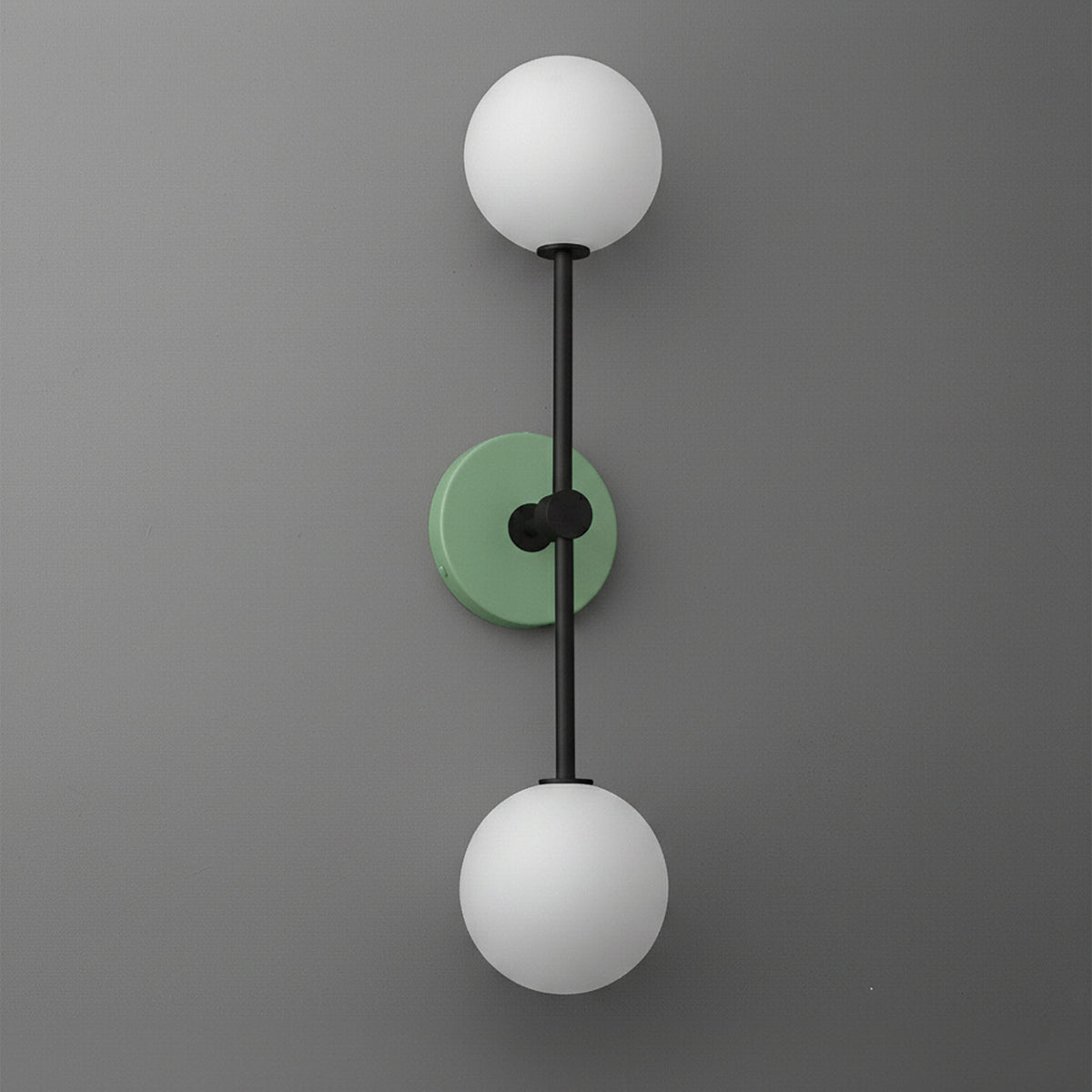 Wall sconce with black metal frame, green round backplate, and two white globe glass shades. - SCONCE MODEL NO. 9776