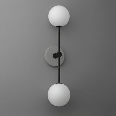 Wall sconce with double white frosted glass globes and matte black vertical metal frame on gray wall. - SCONCE MODEL NO. 9776