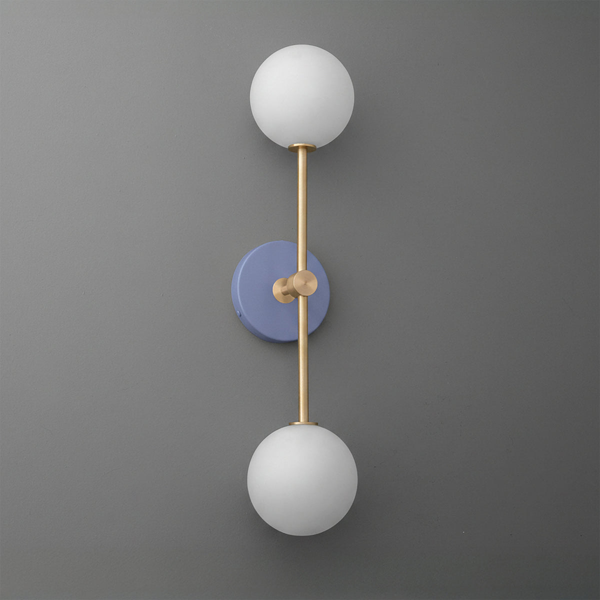 Wall sconce with raw brass frame and two white frosted glass globes on periwinkle round base. - SCONCE MODEL NO. 9776