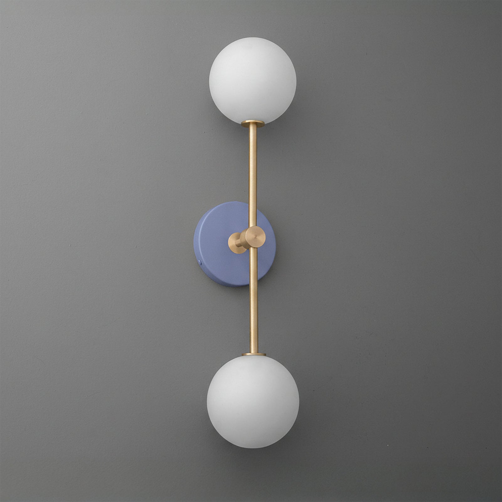 Wall sconce with raw brass frame and two white frosted glass globes on periwinkle round base. - SCONCE MODEL NO. 9776