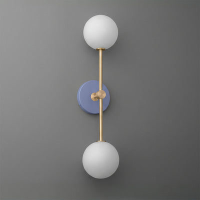 Wall sconce with raw brass frame and two white frosted glass globes on periwinkle round base. - SCONCE MODEL NO. 9776