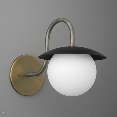 Wall sconce with a round brass base, curved metallic arm, black flat dome shade, and white glass globe bulb diffuser. - SCONCE MODEL NO. 2206
