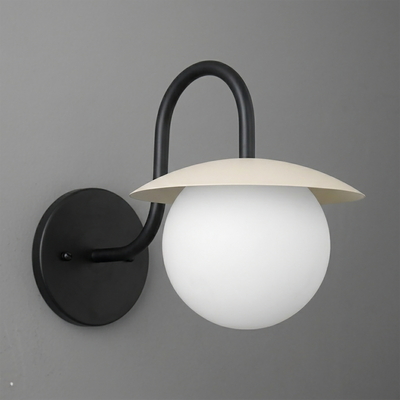 Matte black metal wall sconce with a curved arm and round white glass globe shade topped by a flat cream-colored metal disc. - SCONCE MODEL NO. 2206