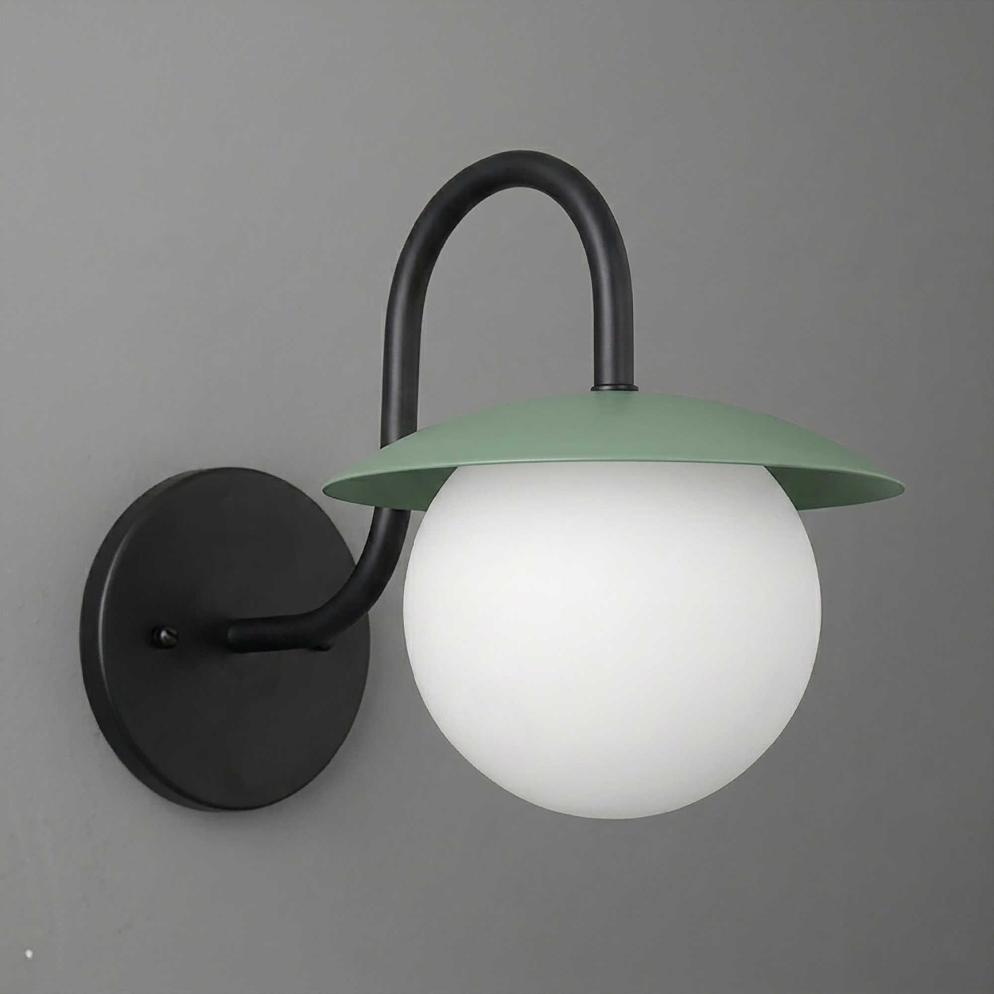 Matte black metal wall sconce with curved arm and matte green flat dome shade over white frosted glass globe bulb cover. - SCONCE MODEL NO. 2206