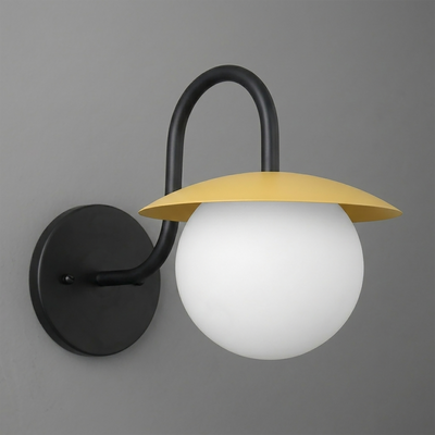 Black metal wall sconce with curved arm and round matte white glass globe under flat yellow shade. - SCONCE MODEL NO. 2206