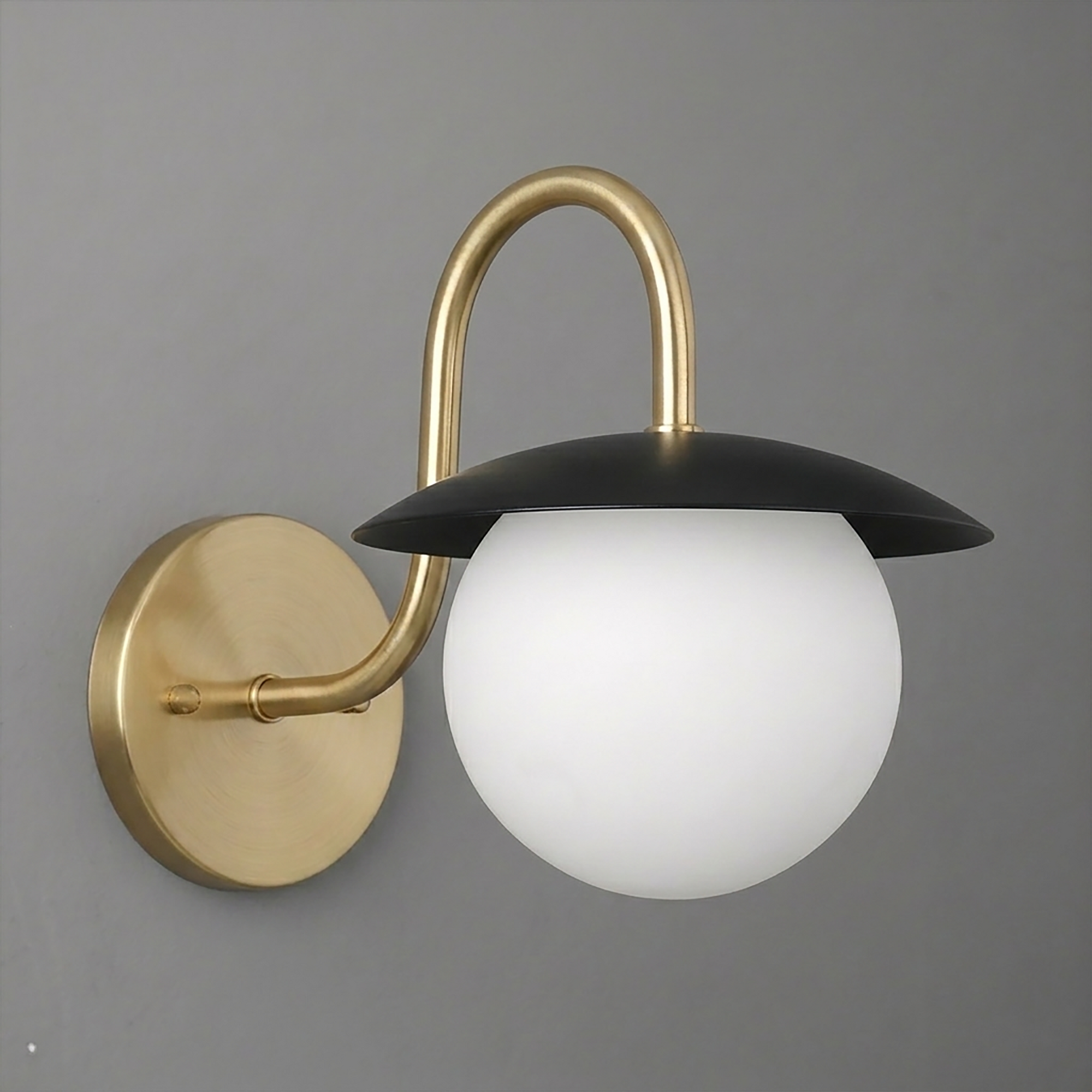 Wall sconce with matte black dome shade, frosted white glass globe, and brushed brass curved arm and round base plate. - SCONCE MODEL NO. 2206