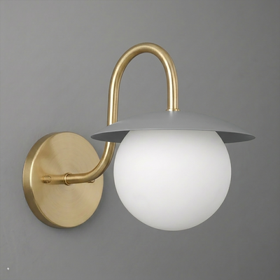 Wall-mounted sconce with a brushed brass curved arm, circular backplate, white frosted glass globe, and flat gray metal. - SCONCE MODEL NO. 2206