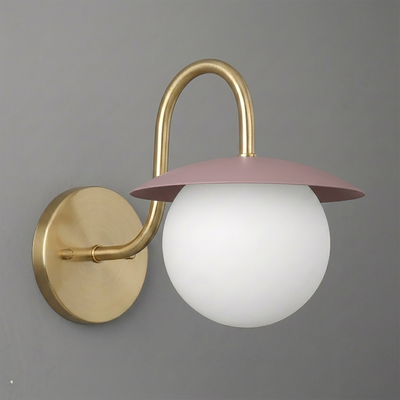 Wall sconce with matte gold metal base and curved arm, pink flat dome shade, and white frosted glass globe bulb cover. - SCONCE MODEL NO. 2206