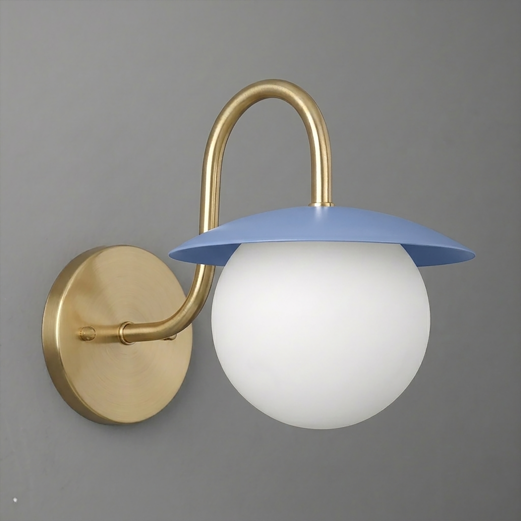 Brushed brass wall sconce with curved arm, blue metal shade, and white frosted glass globe bulb cover. - SCONCE MODEL NO. 2206