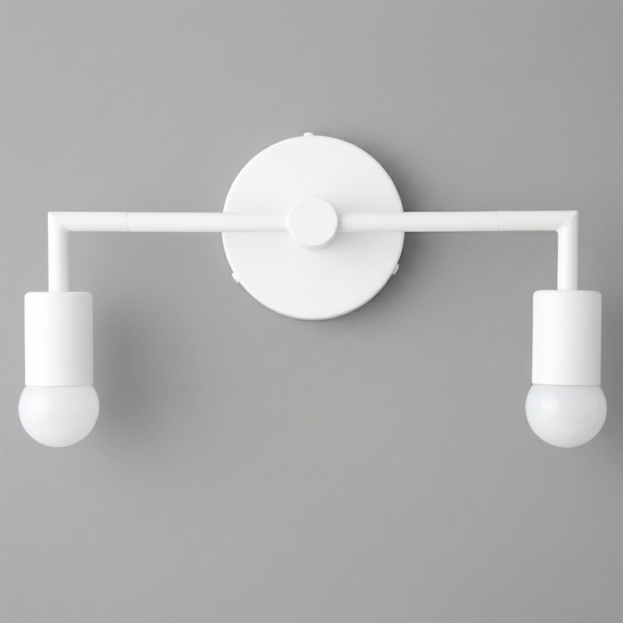 White Scandinavian-style vanity light with two exposed bulbs and a round wall mount. - VANITY LIGHT MODEL NO. 1561
