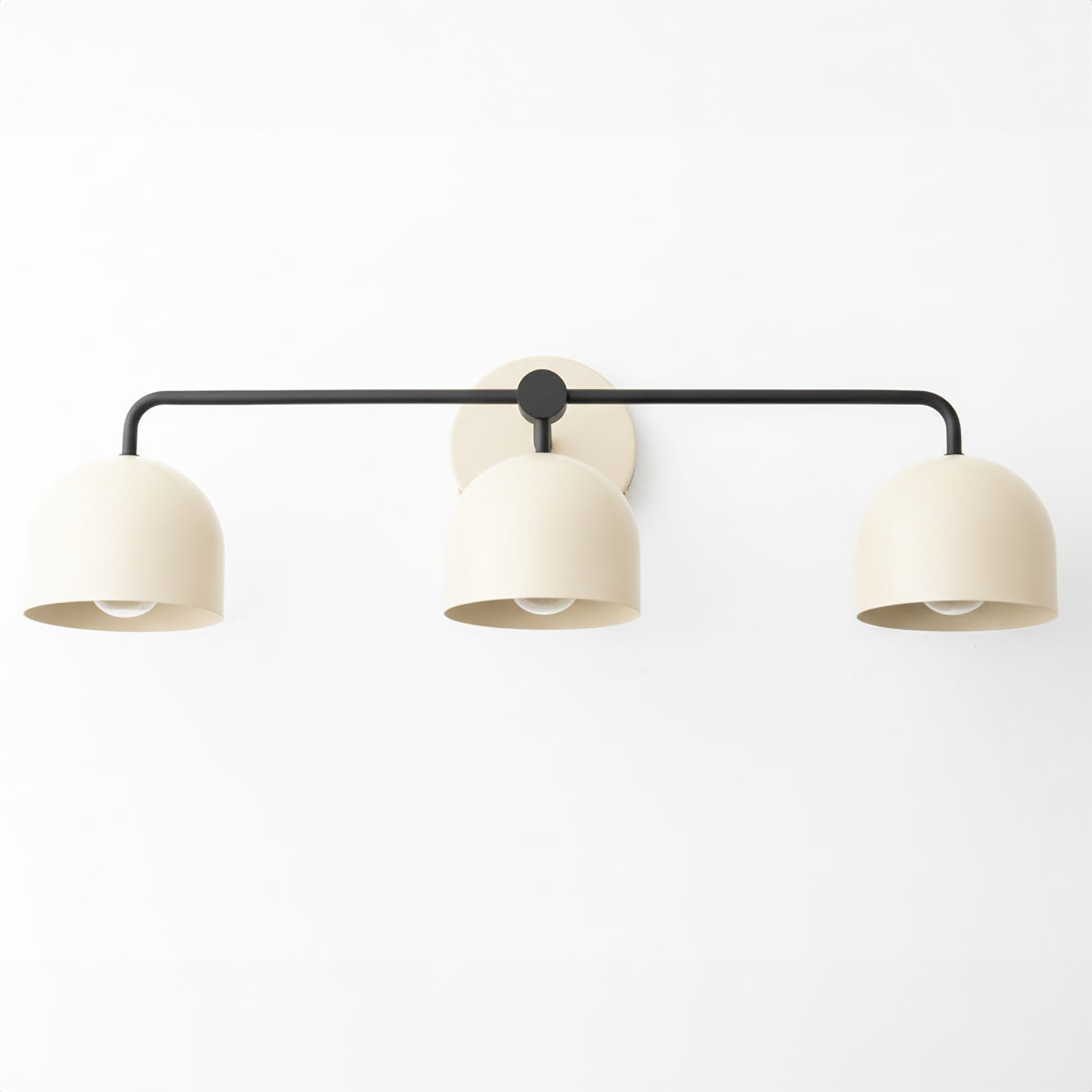 Mid-century modern vanity light with three matte beige dome shades on a black horizontal metal bar and round wall mount. - VANITY LIGHT MODEL NO. 7456