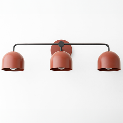 Three-bulb matte brick red vanity light with black metal frame and round wall mount. - VANITY LIGHT MODEL NO. 7456