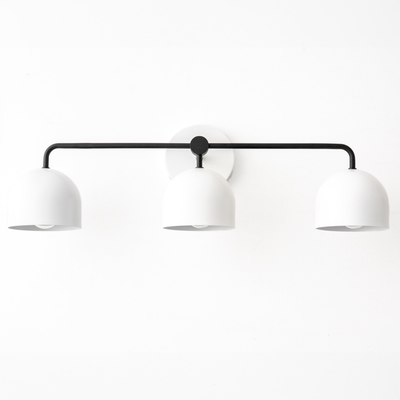 Three-bulb vanity light with black horizontal bar and white dome shades in mid-century modern style. - VANITY LIGHT MODEL NO. 7456