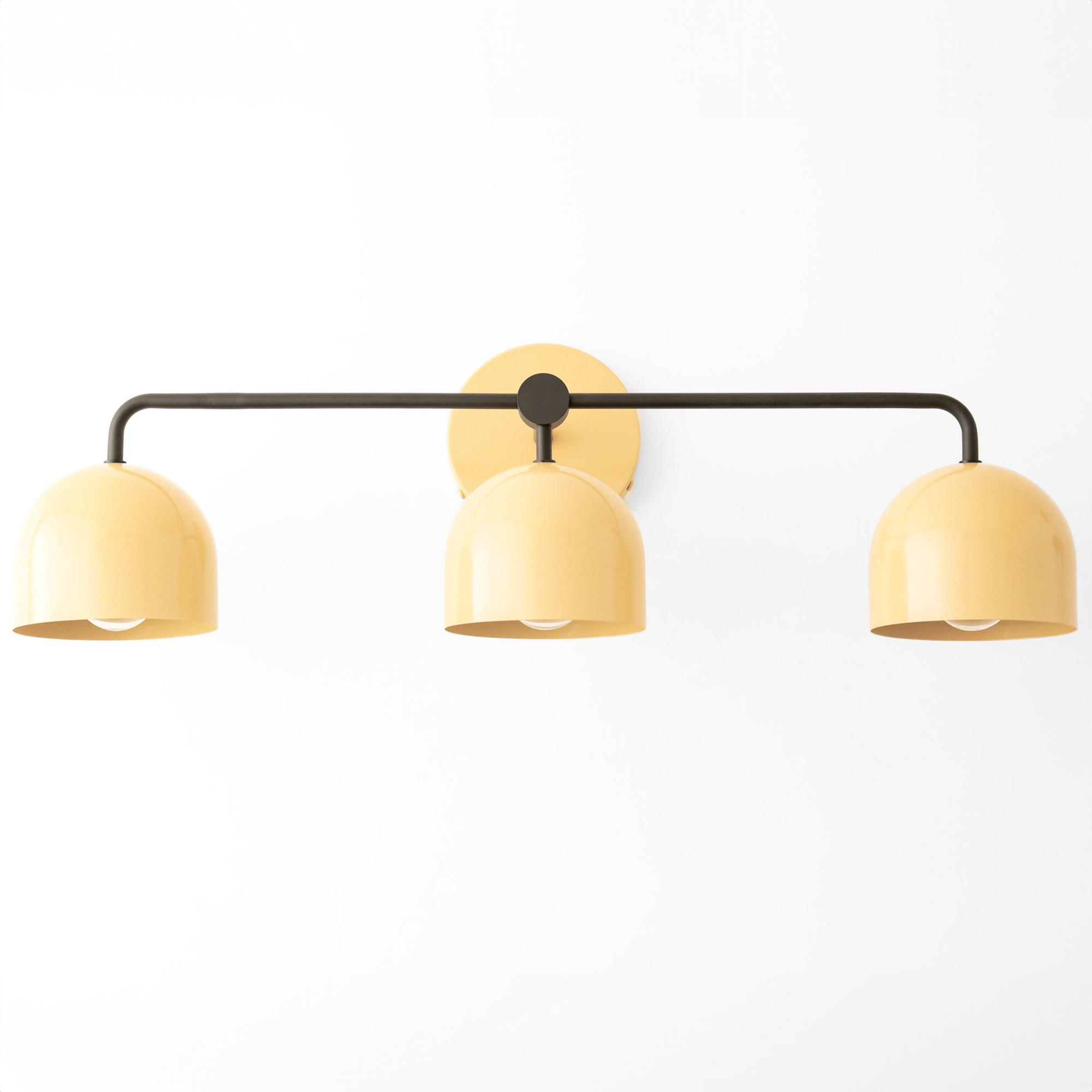 Mid-century modern 3-bulb vanity light with matte yellow dome shades and black metal frame. - VANITY LIGHT MODEL NO. 7456