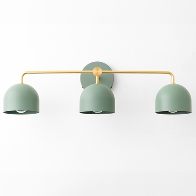 Mid-century modern vanity light with three matte sage green dome shades and brass horizontal bar mount. - VANITY LIGHT MODEL NO. 7456