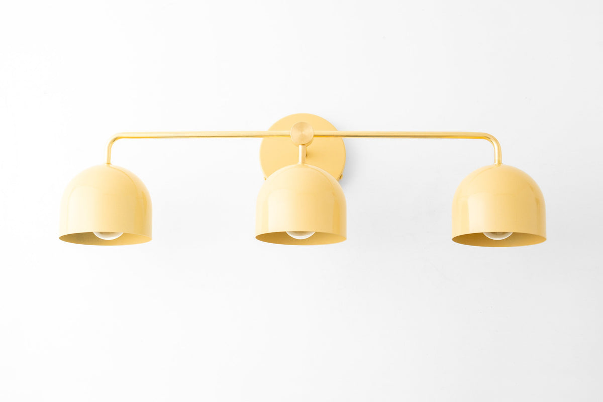 Mid-century modern 3-bulb vanity light with matte yellow dome shades and slim metal frame. - VANITY LIGHT MODEL NO. 7456