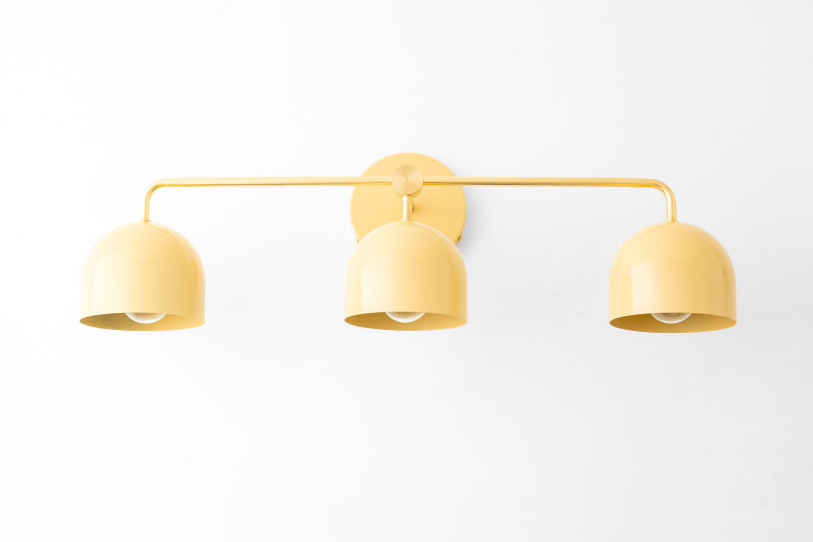 Mid-century modern 3-bulb vanity light with matte yellow dome shades and slim metal frame. - VANITY LIGHT MODEL NO. 7456