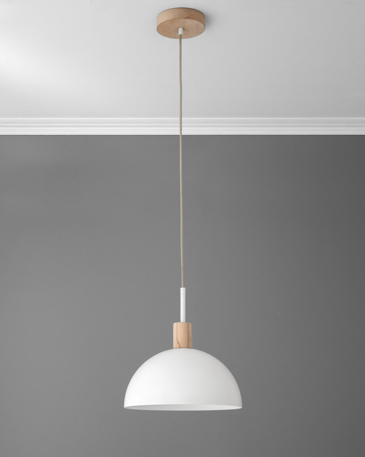 White dome pendant light with tan wood accent and matching tan cord against gray wall. - PENDANT MODEL NO. 4610