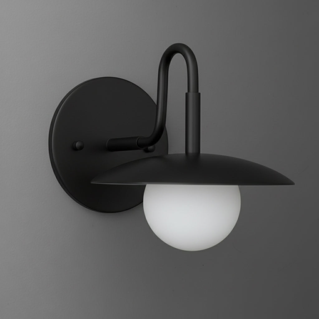 Matte black metal wall sconce with curved arm and frosted white glass globe shade. - SCONCE MODEL NO. 1078