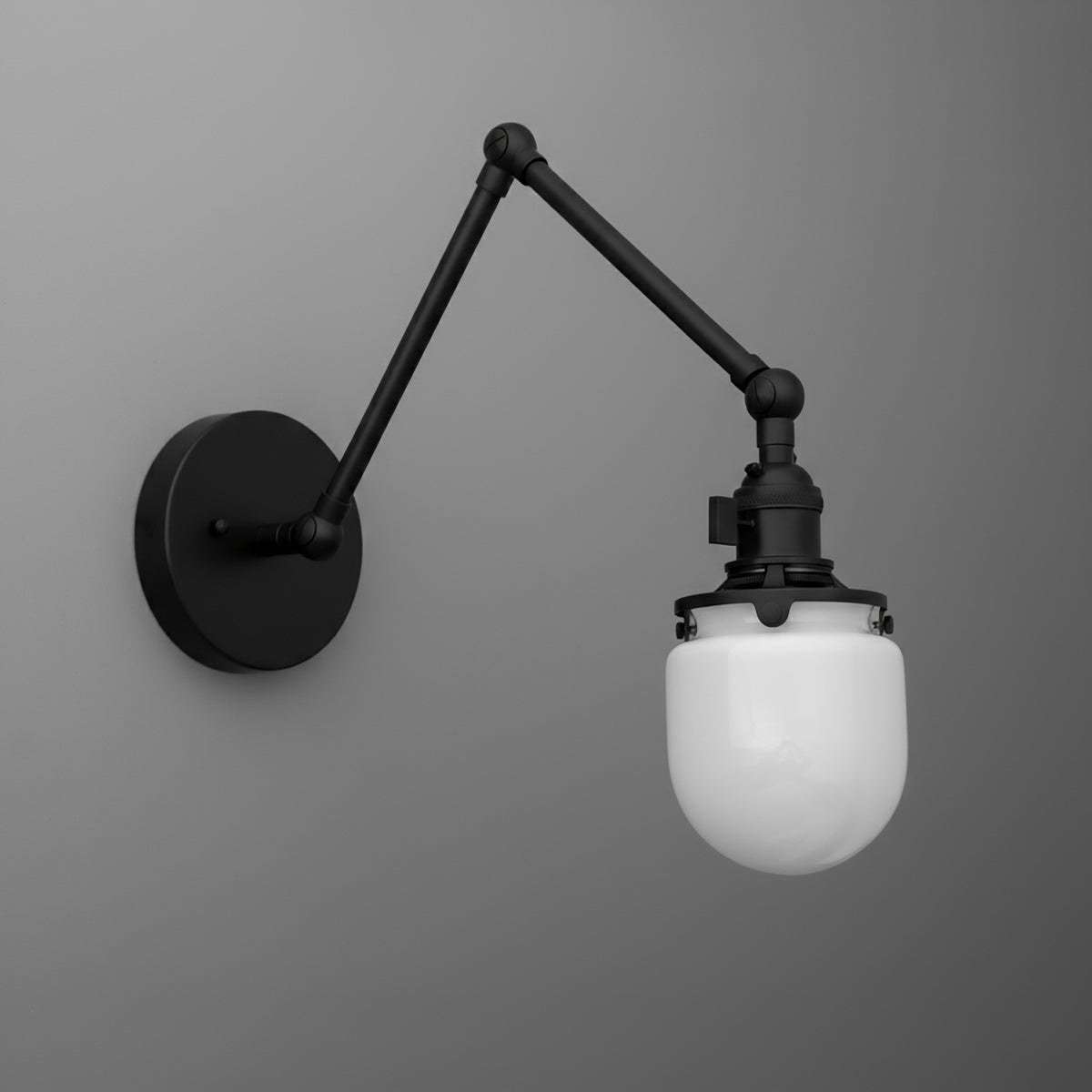 Black metal wall sconce with adjustable arm and frosted white glass globe shade. - SCONCE MODEL NO. 7575